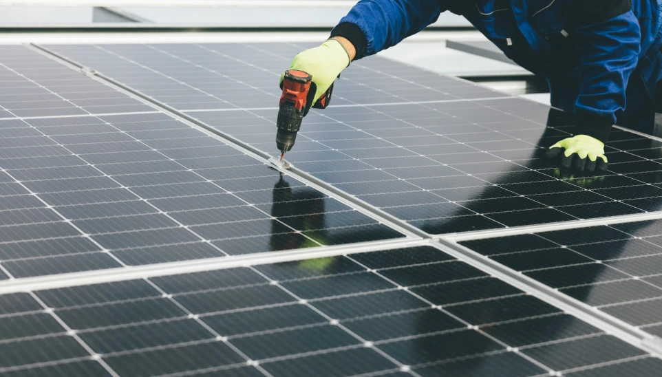 a person working on a solar panel
